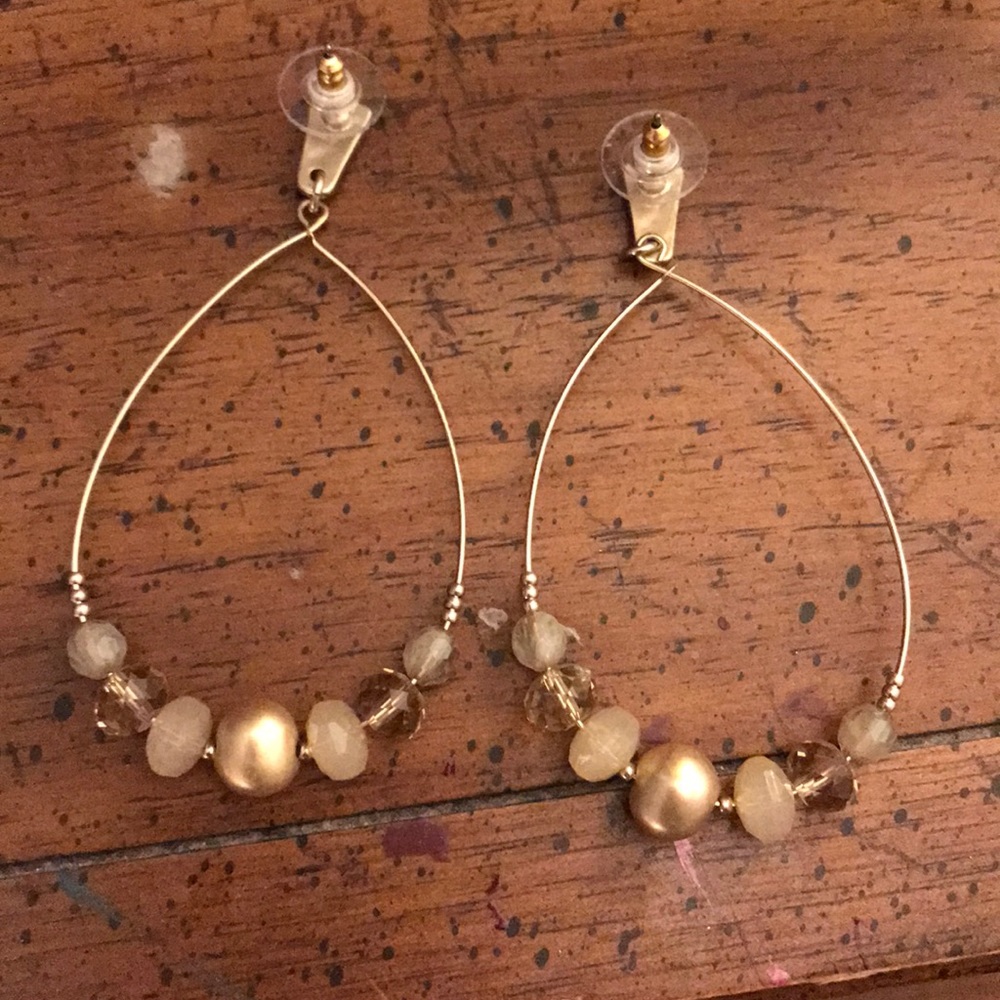 Long gold beaded earrings with clear back .